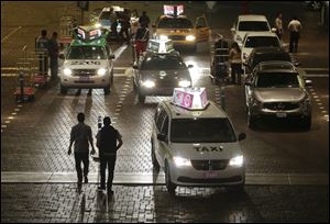Tourists approach a taxi stand Friday at the Venetian Hotel-Casino in Las Vegas, where one company called for a strike.