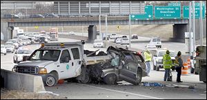 Police say a vehicle struck an Ohio Department of Transportation vehicle as two workers were at the side of the road picking up litter. The unoccupied truck was pushed 35 to 40 feet, landing directly under the Bancroft Street overpass in Monday’s accident, police say.