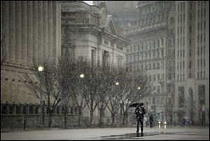 A pedestrian walks down Pennsylvania Ave near the White House in Washington, today.