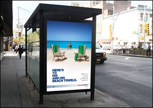 This American Airlines ad at a bus stop shows a male couple in the background. Part of the ad says, 'Proud to support the community that supports us.'