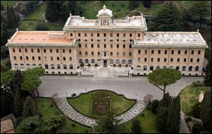 The floral decorations in front of the Vatican Governor's Palace depicting the coat of arms of the Holy See and of the State of Vatican City, with the crossed keys surmounted by the tiara, and with the empty lower half that was left after Pope Benedict XVI's coat of arms was removed after his resignation of Feb. 28, 2013.