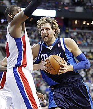 Dirk Nowitzki of Dallas drives against Detroit's Greg Monroe.