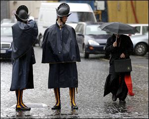 A cardinal leaves after a meeting at the Vatican, which announced the conclave would start Tuesday.