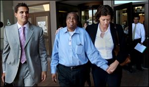 David Ayers, center, was awarded $13.2M for his pain and suffering, and brings an end to the legal battle he's been fighting since his arrest in the 1999 killing of 76-year-old Dorothy Brown.