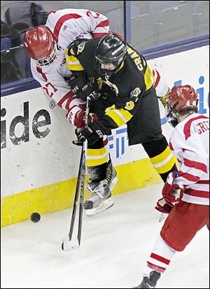 Northview's Drew Crandall (15) battles a pair of players from Shaker Heights for control of the puck during the second period.