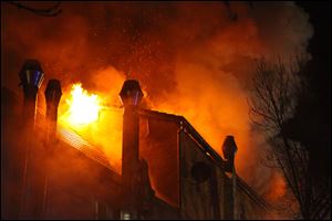 Flames rise at a house in Backnang, Germany today.