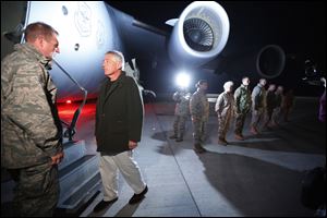 Defense Secretary Chuck Hagel prepares to step aboard a C-17 military aircraft en route to Kabul, Afghanistan, after greeting U.S. troops stationed at Manas Air Force Base in Kyrgyzstan.