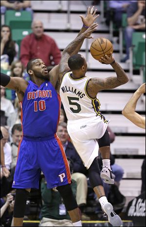 Utah Jazz's Mo Williams (5) shoots as Detroit Pistons' Greg Monroe (10) defends in the first quarter during an NBA basketball game.