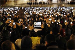 Visitors take photos of Pope Francis, who was chosen today as the 266th pontiff of the Roman Catholic Church.