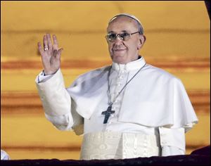 Pope Francis — Cardinal Jorge Bergoglio of Argentina — greets the crowd from the central balcony of St. Peter's Basilica at the Vatican. He is the 266th Pontiff of the Roman Catholic Church. 