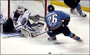 Greenville goalie Scott Stajcer deflects a shot by the Walleye's Stephon Thorne.