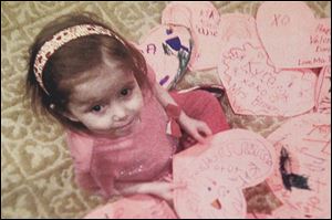 Kyra Conrad, 4, looking over the Valentines she received, was diagnosed with multiple intestinal atresia and immunodeficiency disorder, two conditions that cause a compromised immune system. Because of her conditions, Kyra can’t attend school.