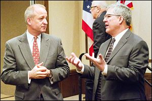 Donald Templin, left, chief financial officer of Marathon Petroleum in Findlay, and Ford Weber, president of the Northern Ohio Regional Economic Development Association, discuss the agenda before Thursday’s annual meeting of NORED at the Holiday Inn French Quarter in Perrysburg. 
