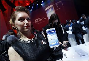 The new Samsung Galaxy S 4 is presented during the Samsung Unpacked event at Radio City Music Hall, Thursday, March 14, 2013 in New York.