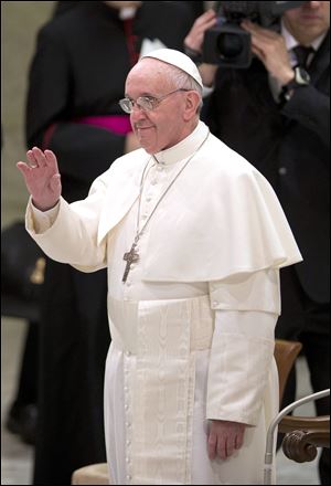 In this photo released by the National Conference of Brazilian Bishops, Pope Francis, left, is seen aboard a minibus with other Cardinals at the Vatican, the day after his election.