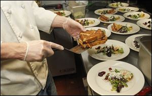 A Monte Cristo and jelly sandwich is added to a plate at The Blarney.