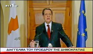 In an image made from video, Cyprus' President Nicos Anastasiades addresses the nation in a broadcast on Sunday about trying to amend a bailout plan.