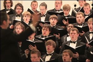 Timothy Cloeter, left, directs the Bowling Green State University Men's Chorus, which performed at the First United Methodist Church in Perrysburg. Last week the group returned from a Spring tour which took them to Georgia, Florida, and South Carolina, as well as Ohio.