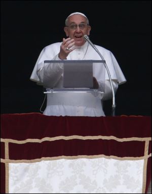 Pope Francis delivers his Angelus prayer from the window of his studio overlooking St. Peter's Square, at the Vatican early today.