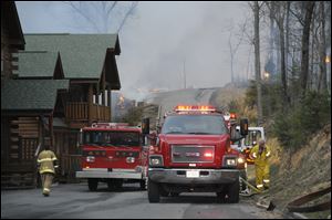 Fire crews try to keep a contain on large fire on Black Bear Cub Way in Sevier County Tenn., Sunday.