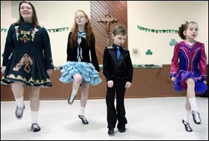 Luke Morelock, 8, center right, watches fellow members of the Ardan Academy of Irish Dance, from left, Reagan McLaughlin, Camille Morelock, and Adelie Semproch. The children performed Sunday at the annual festival sponsored by the Hibernians at the Knights of Columbus hall in West Toledo.