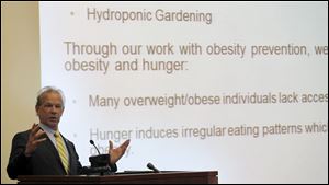 Randy Oostra, president and CEO of ProMedica, speaks during the Come to the Table: Building a Hunger-Free Region summit at the Toledo-Lucas County Library in Toledo.