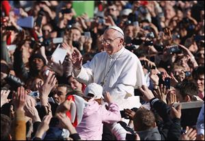 Pope Francis is greeted by a crowd of 200,000  as he arrives in St. Peter’s Square for his Inaugural Mass at the Vatican.  The crowd Tuesday ranged from kings to beggars, including dignitaries from more than 130 nations.