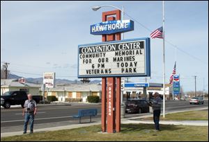 A sign telling residents about a memorial service is posted at the Convention Center in Hawthorne, Nev., near the Hawthorne Army Depot on Tuesday where seven Marines were killed and several others seriously injured in a training accident.
