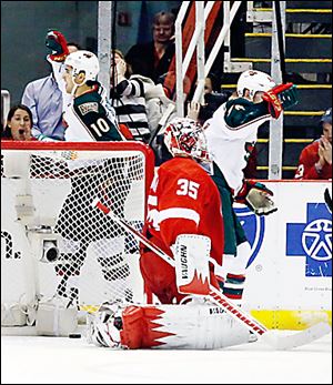 The Wild’s Devin Setoguchi, left, scored two goals against Red Wings goalie Jimmy Howard.