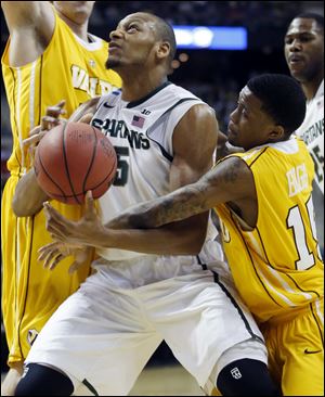 Michigan State forward Adreian Payne (5) is fouled by Valparaiso guard Erik Buggs (15) while trying to go to the basket Thursday in Auburn Hills, Mich.