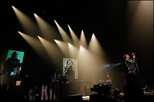 Kid Rock performs for a sold-out crowd at the Huntington Center on Friday. The concert blended hard rock, rap, country, and rhythm and blues — and included a pair of Shriners in maroon fezzes.    