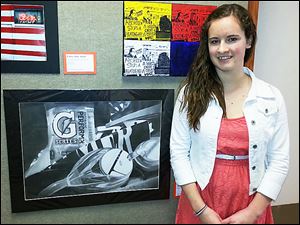 Dana Richards, a junior at Whitmer High School, shows off her first-place entry, ‘Hopes and Dreams,’ from the annual Congressional Art Competition. 