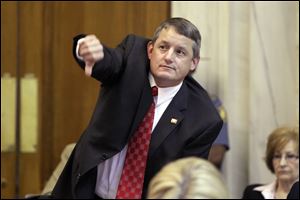 Arkansas House Majority Leader Rep. Bruce Westerman, (R., Hot Springs), signals his intention to speak against a Medicaid funding bill in the House chamber at the Arkansas state Capitol in Little Rock, Ark., April 16.