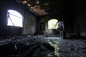 A Libyan man investigates the inside of the U.S. Consulate on Sept. 13, 2012, after an attack that killed four Americans, including Ambassador Chris Stevens.