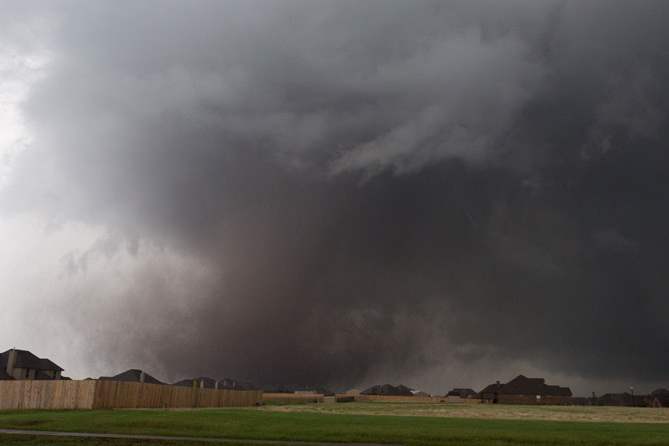 A-tornado-moves-past-homes-in-Moore