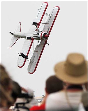 Wing walker Jane Wicker, 46, waves to the crowd seconds before the plane hit the ground. ‘Jane was one of our industry’s stars,’ said the president of a trade group. 