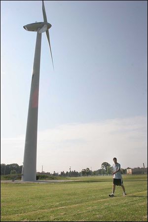 UT student Bryce Schide surveys the land around the Clay High wind turbine, seeking birds and bats that may have been injured or killed.