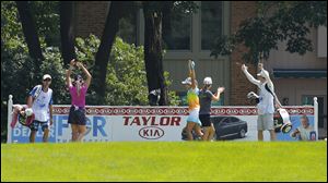 Lexi Thompson, center, celebrates with playing partners Paula Creamer, left, and Beatriz Ricari, right, and their caddies after she hit a hole-in-one on No. 14 during the final round of the Marathon Classic at Highland Meadows Golf Club in Sylvania.