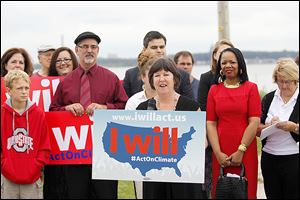 Lucas County Commissioner Tina Skeldon Wozniak, front center, emcees the ‘I Will Act On Climate’ news conference hosted by a coalition of community leaders at Toledo’s Cullen Park Boat Launch.