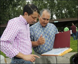 Eugenio Mollo, left, chats with Francisco Espinoza during the event. Mr. Mollo is vice chairman and Mr. Espinoza is chairman of the Farmworker Agencies Liaison Communication and Outreach Network, which sponsored the appreciation day.