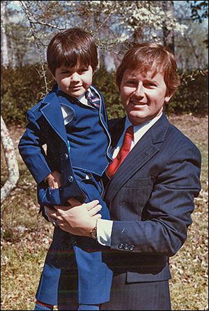 Lucas County Auditor Dan McNamara holds his son, Joe. Mr. McNamara was killed in a freak accident in 1983.
