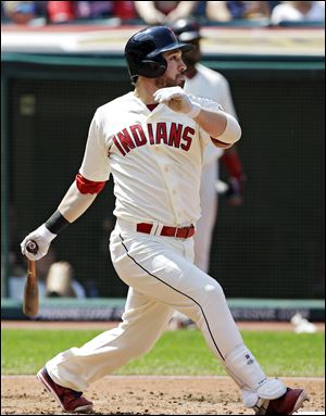 The Indians' Jason Kipnis singles to drive in a run against the Minnesota Twins in the third inning Sunday in Cleveland.