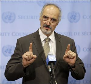Syrian Ambassador to the United Nations Bashar Ja'afari speaks to reporters.