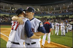 Toledo Mud Hens manager Phil Nevin gets a hug from Kenny Faulk after the Hens' win. Nevin was notified that his contract would not be renewed shortly after the game.