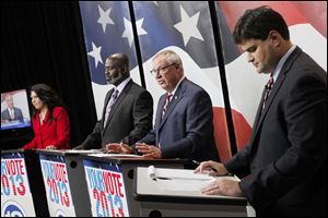 With a week to go before the primary, the candidates — Anita Lopez, Mayor Mike Bell, D. Michael Collins, and Joe McNamara, from left — came out swinging at each other’s stances.