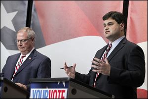 D. Michael Collins, left, listens and fellow councilman Joe McNamara answers a question. Both men, as well as Mayor Mike Bell, blasted rival Anita Lopez for what they saw as her failure to directly answer questions.  