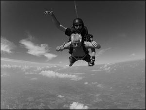 The author experiences free fall while strapped to an experienced jumper.