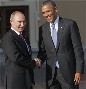 Russia's President Vladimir Putin, left, shakes hands with U.S. President Obama during arrivals for the G-20 summit at the Konstantin Palace in St. Petersburg, Russia.