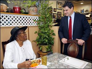Toledo mayoral candidate Joe McNamara talks with Dorothy Murchison  while campaigning  at Ruby's Kitchen Sunday, 09/09/13, in Toledo, Ohio.