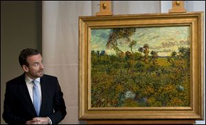 Van Gogh Museum director Axel Ruger, left, looks at 